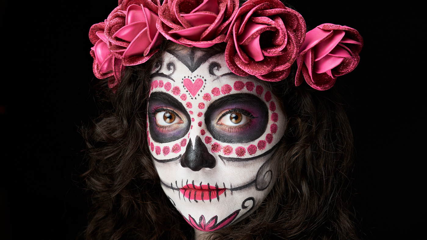 female with full halloween make up in a day of the dead style