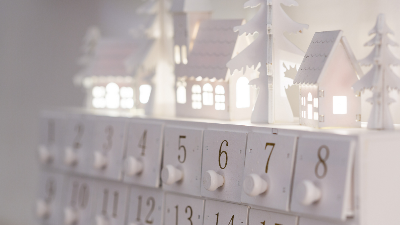 close up of white wooden advent calendar with fillable drawers