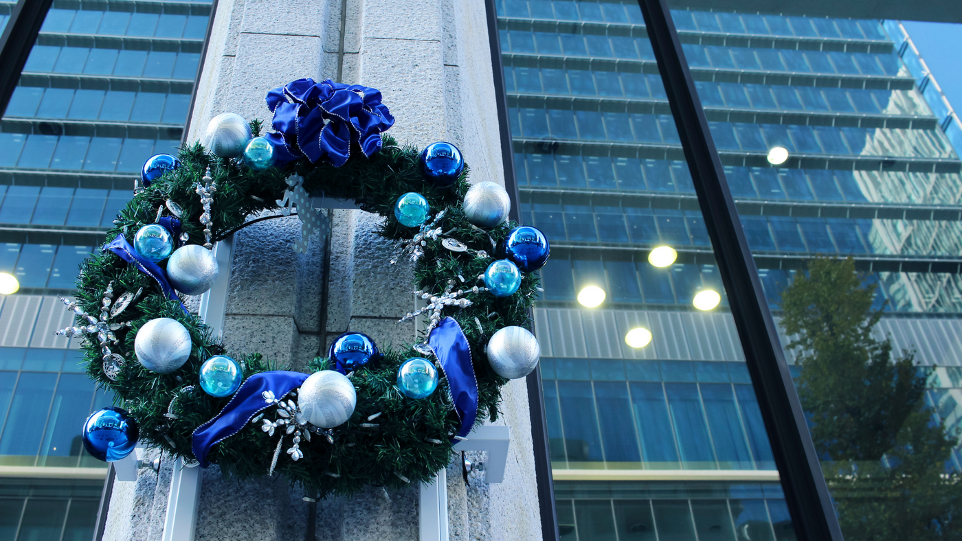 giant wreath decorated with blue baubles on a business building window