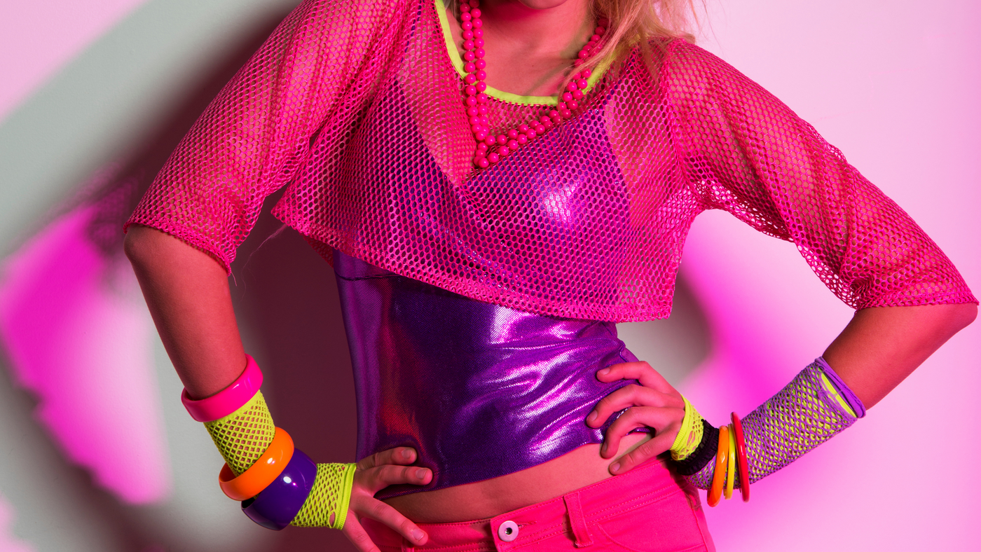lady dressed in 80's costume with fishnet top, neon bracelets and necklace
