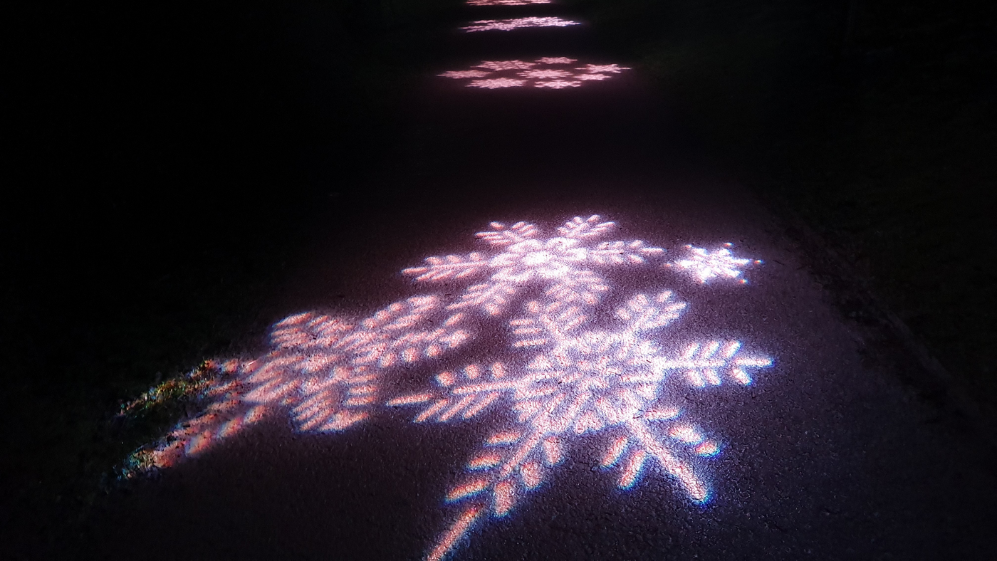 snowflake light projected on ground 