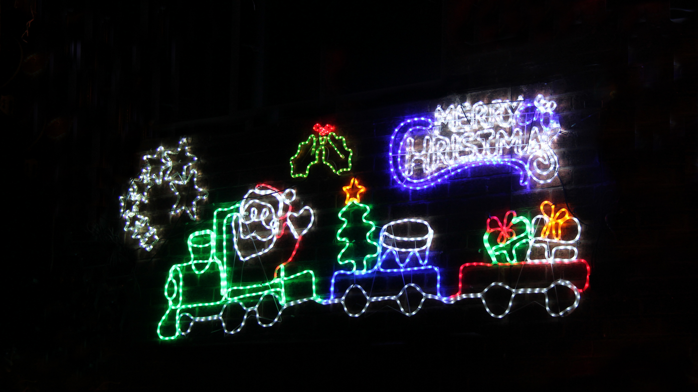 range of large rope light christmas decoration on a brick wall