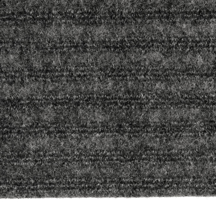 Close up detail of the pile on a grey ridged door mat for indoor use