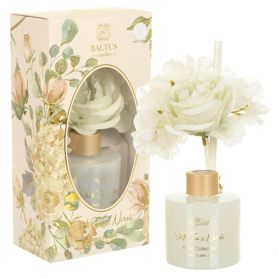 White Tea and Neroli scented reed diffuser with white faux flowers and white glass bottle