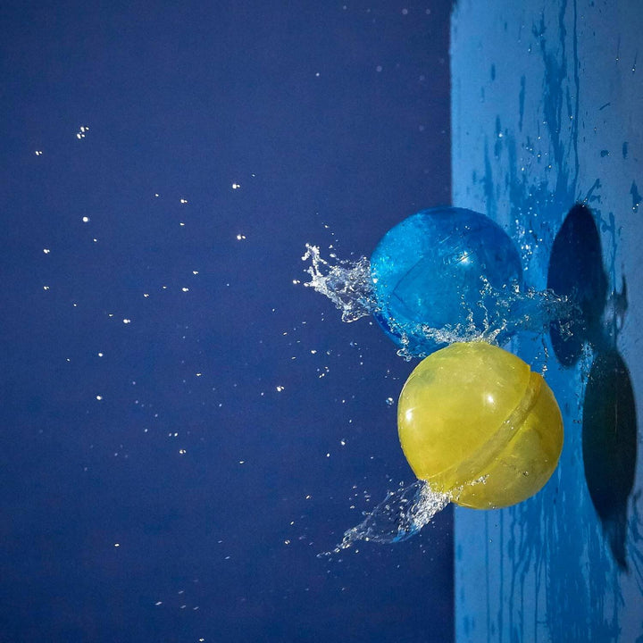 a blue and a yellow water ball hitting a wall and bursting on impact