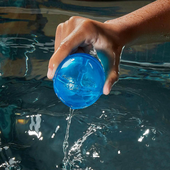 Hand removing a blue Nerf Hydro Ball from water for a water fight