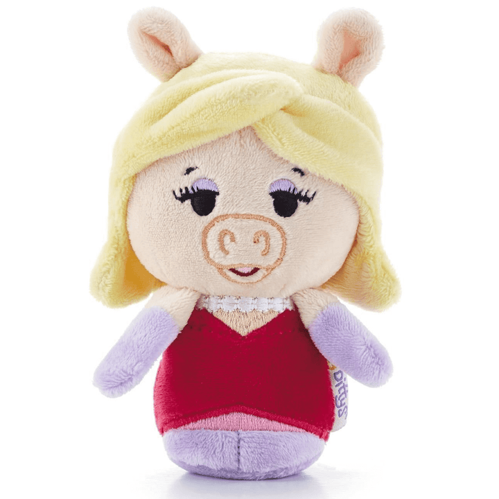miss piffu from the muppets Plush toy of a character with blonde hair, red dress, and pink accents on a white background