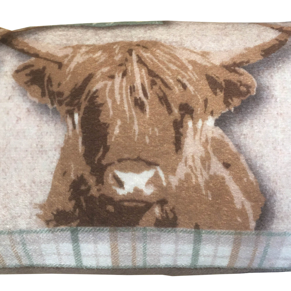 Close up of a highland cow draught excluder with tartan border