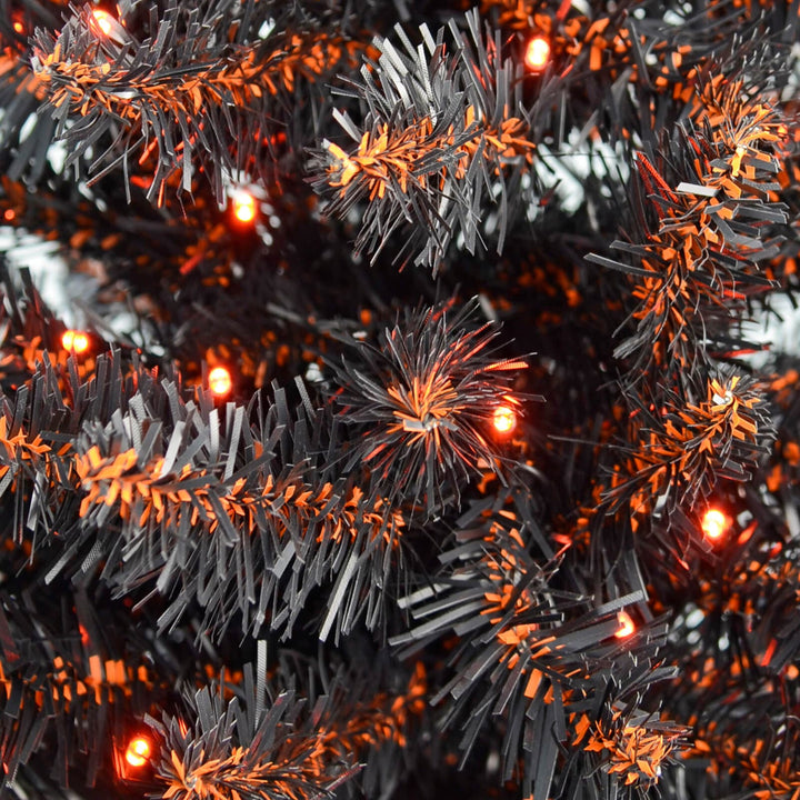 Close up of black Halloween tree branches with orange LED lights