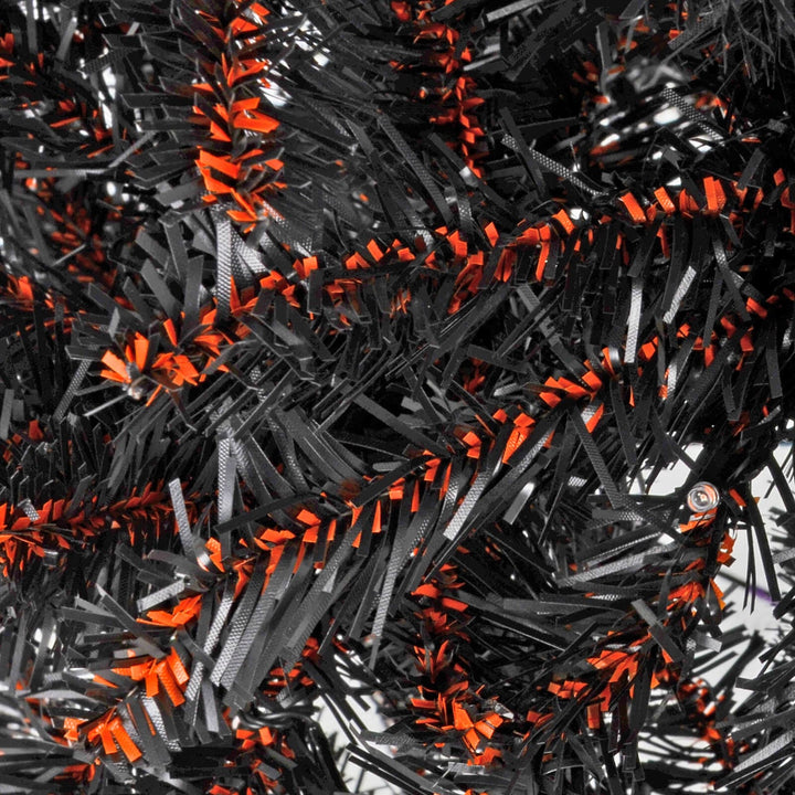 Close up detail of Black and orange Christmas tree branches with LED lights for Halloween
