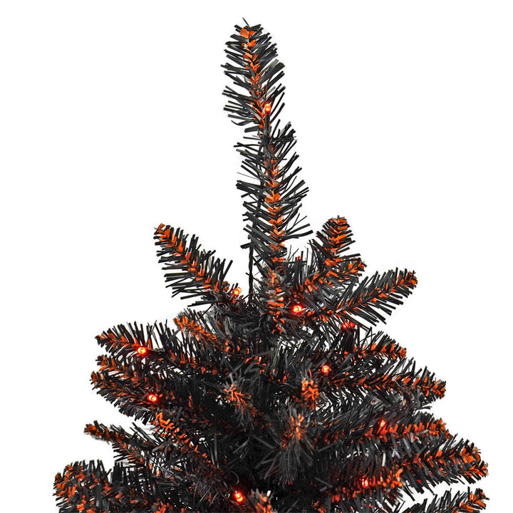 Top of a black and orange halloween tree with orange LED lights
