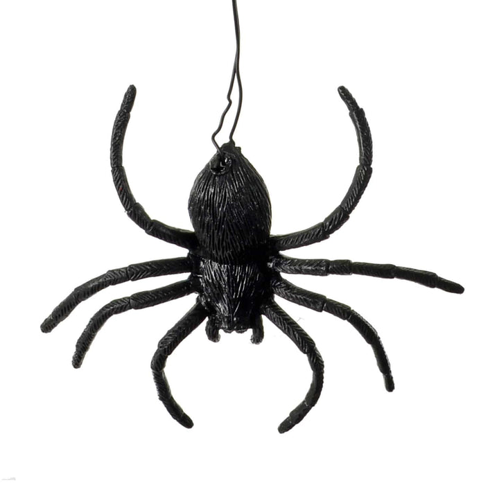 Close up of a plastic black spider on a wire