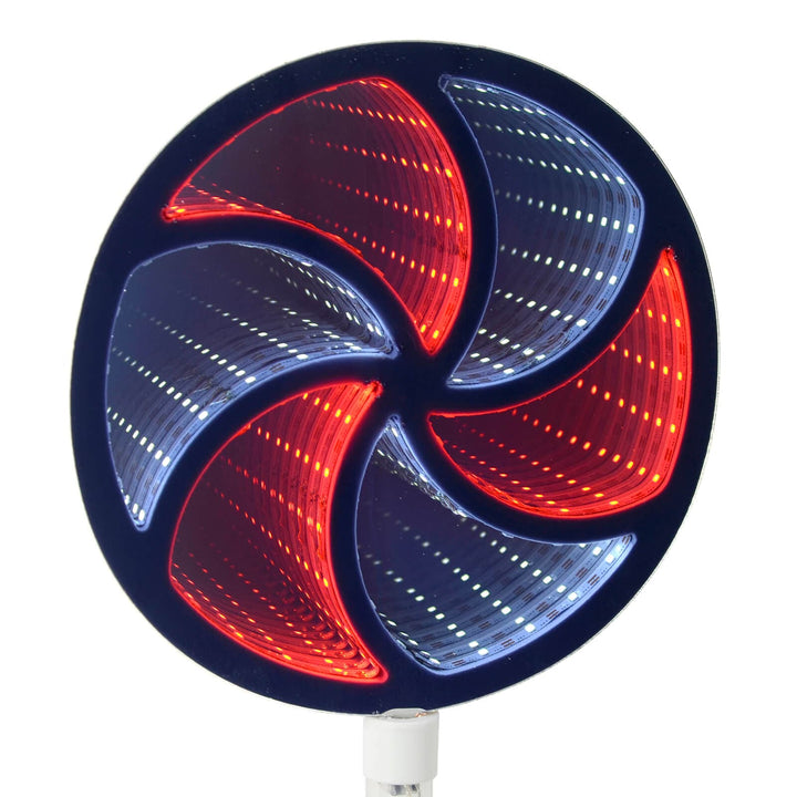 Close up of an infinity mirror pathway light shaped like Christmas candy