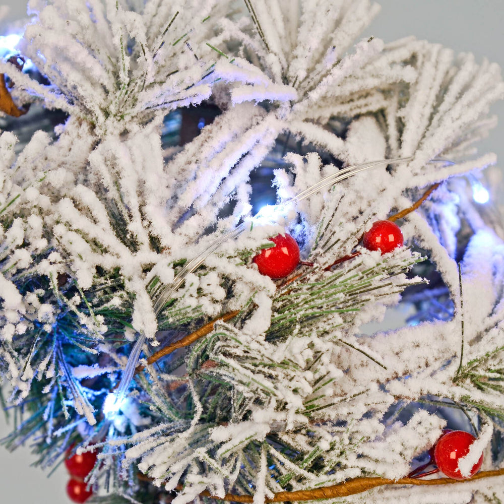 Close up of white lED lights and berries on a Christmas wreath