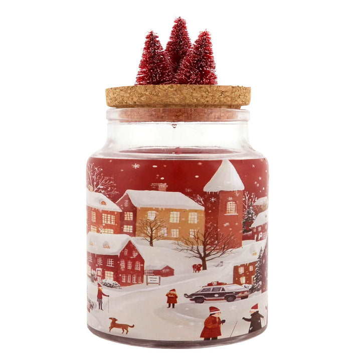 Christmas candle with a winter scene design and cork lid with 3 red trees