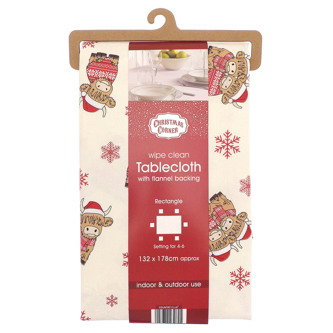 Packaged Christmas-themed tablecloth with Highland Cow design on a white background
