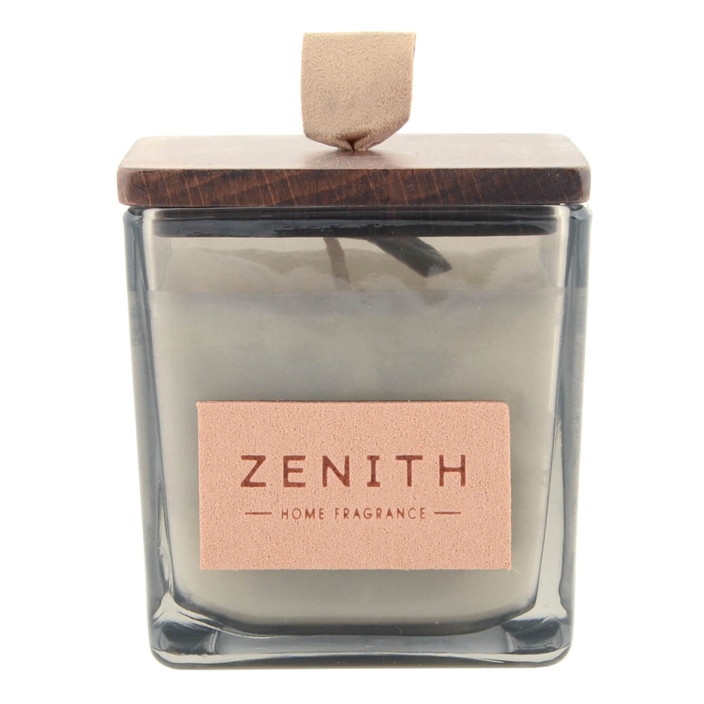 Candle with wooden lid and 'Zenith' label on a white background