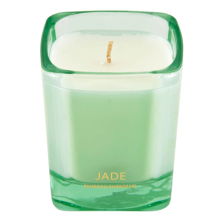 Green candle in a glass container with 'Jade' branding on a white background