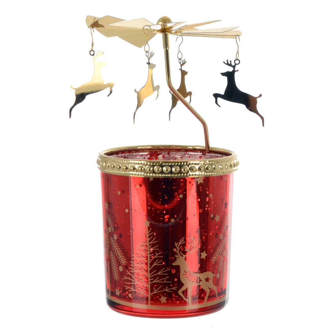 Red carousel candle holder with gold rim and reindeer decorations on a white background