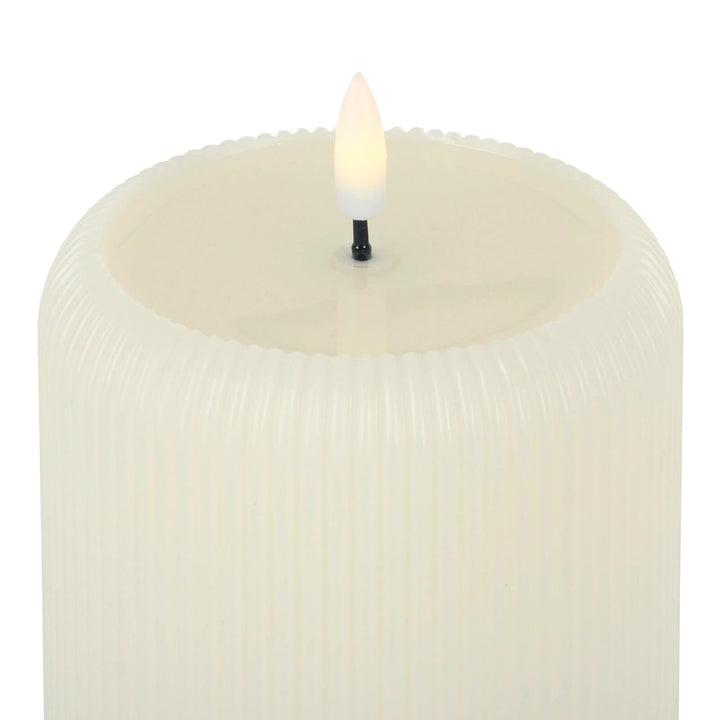 Close up of an LED flicker light candle with real wax