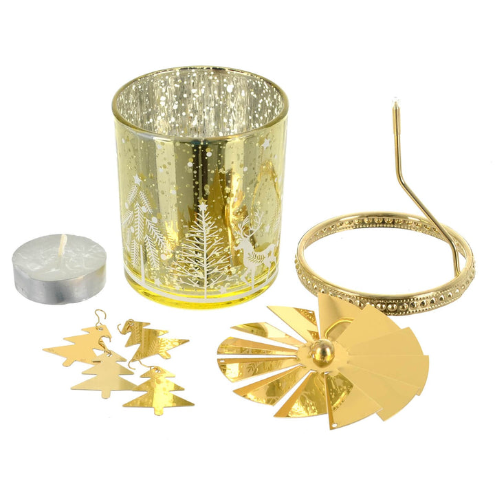 Contents of the box of a gold Christmas carousel rotating candle holder with tea light candle