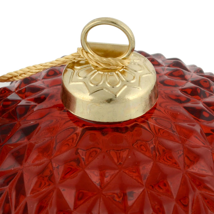 Close up of the top of a red glass Christmas bauble