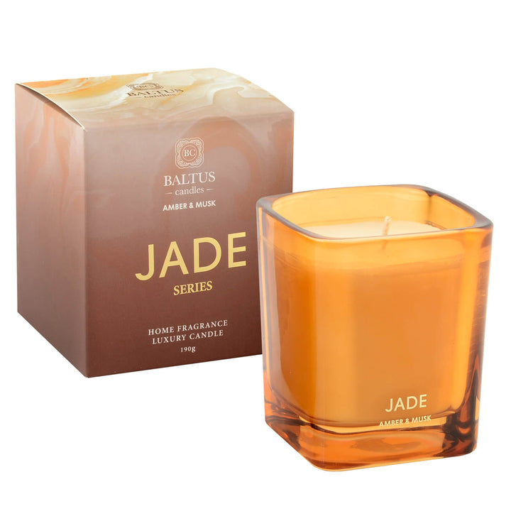 Orange glass candle with gold branding and gift box packaging