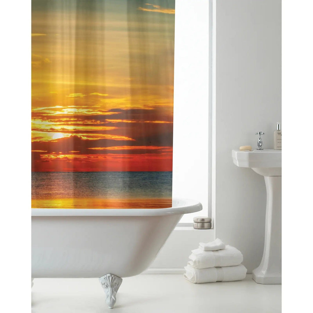 White bathroom with Sunset design shower curtain in shades of orange, yellow and red