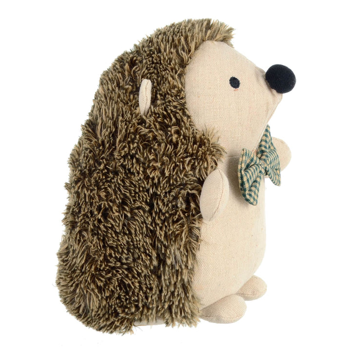 Fabric hedgehog door stopper with a bow tie on a white background