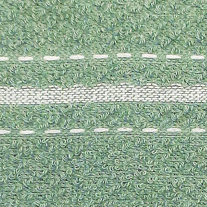 Close-up of a textured green tea towel with white striped stitching