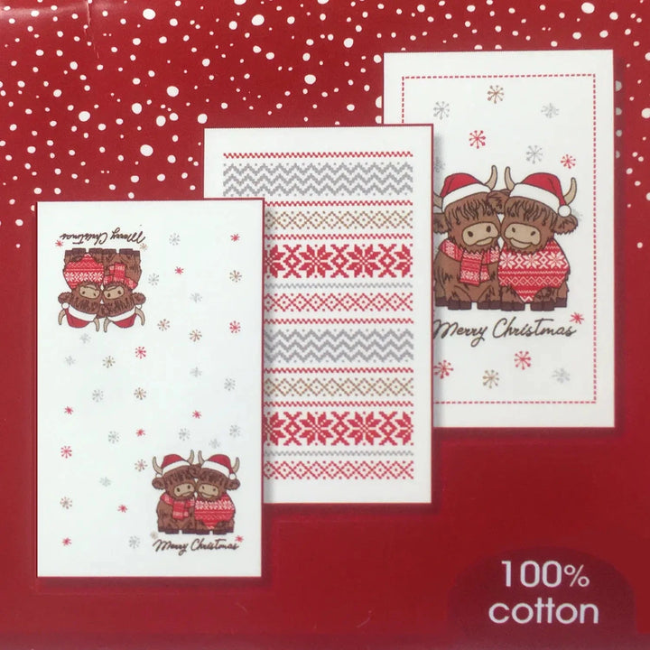 Set of Christmas-themed towels with Highland Cows design on a red background