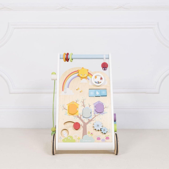 activity walker in room with wood panelled walls featuring colourful baby activities