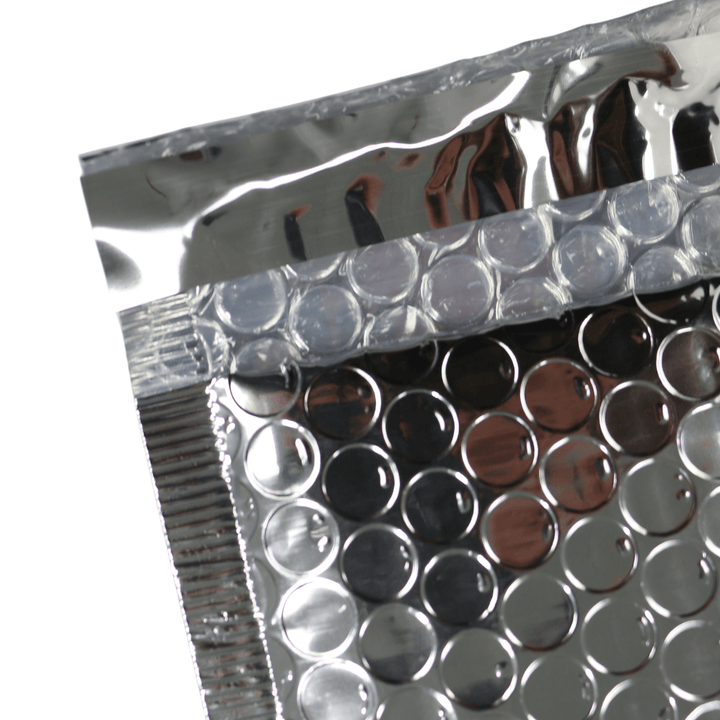 detail shot of silver foil strip covering adhesive on envelope