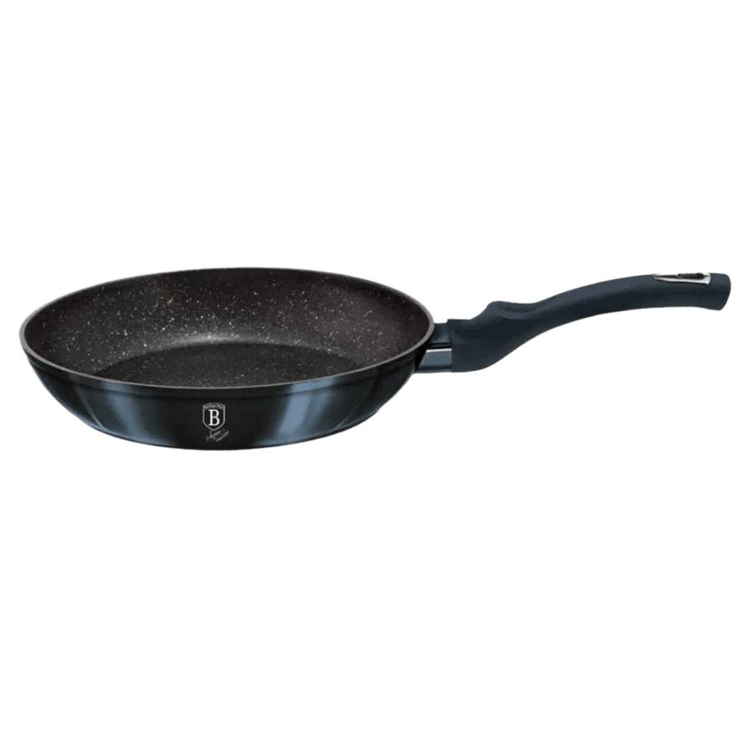 side view Black frying pan with speckled surface on a white background
