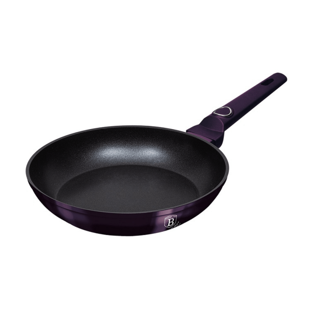 Black frying pan with purple handle on a white background