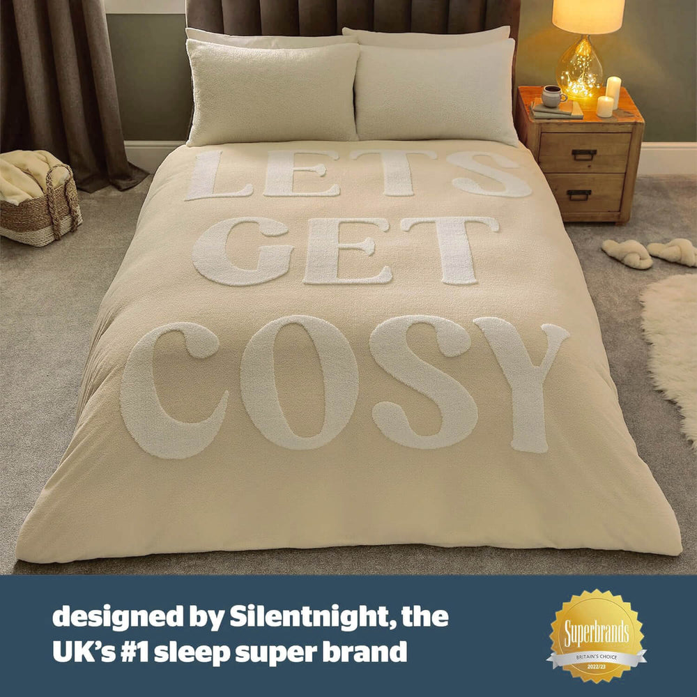 lets get cosy words on a beige and white duvet cover in a cosy bedroom