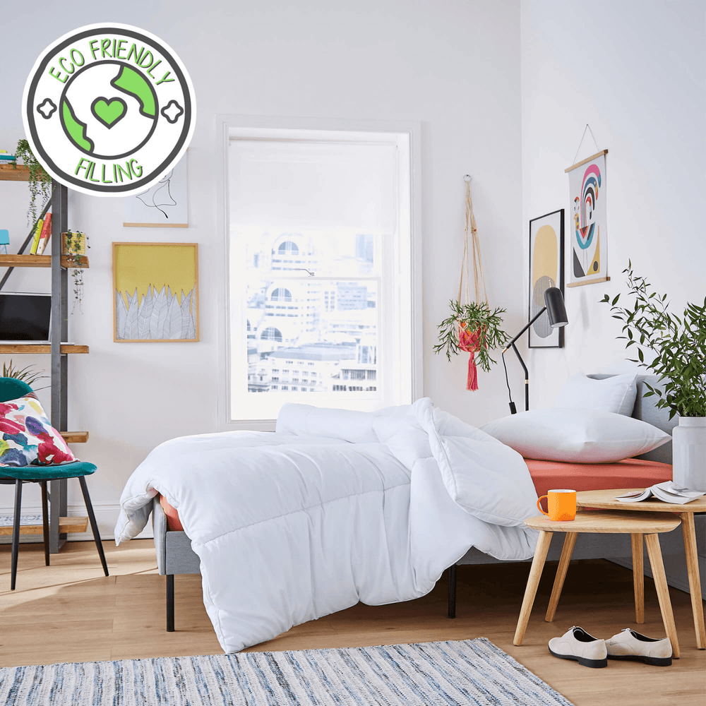 modern bedroom with a white comforter on a bed, 'Eco Friendly' pillow labeled in the corner.