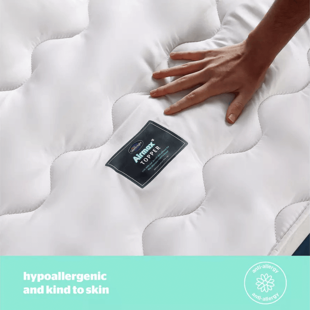 Mattress topper with a hand touching it, featuring Airmax Silentnight branding.