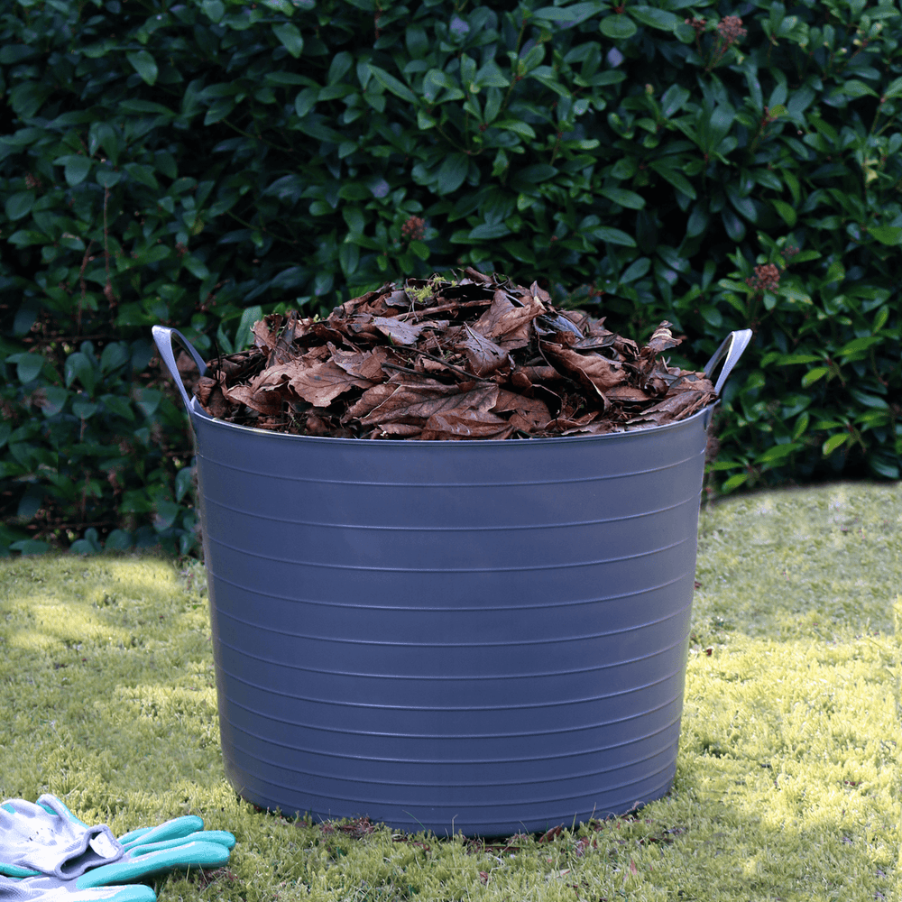 curver flexi tub in garden space filled with leaves with gardening gloves to the side