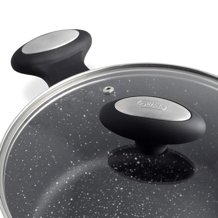 Close up of the glass lid handle on a black casserole pot