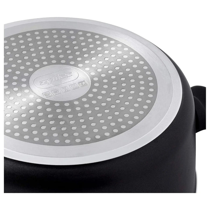 Base of a large black stock pot with circular pattern to distribute heat evenly