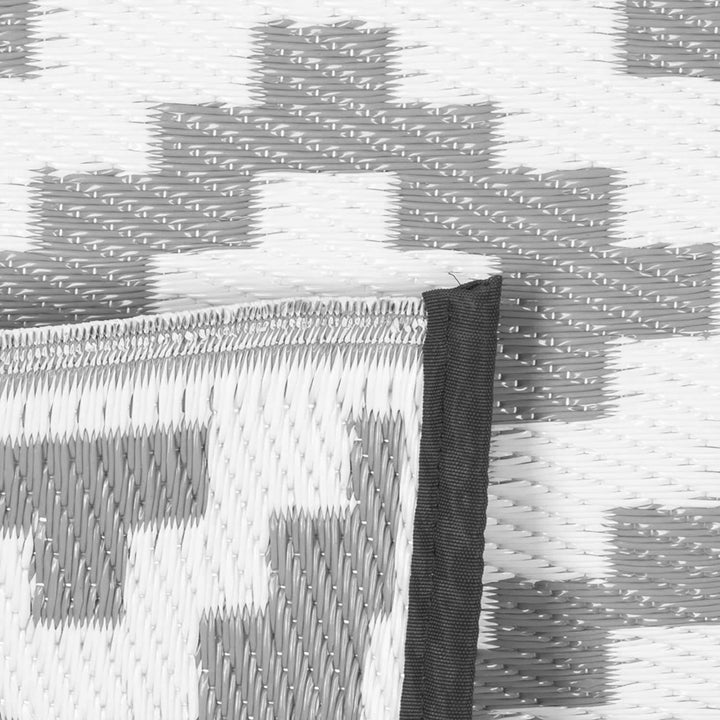 Close up of woven garden rug in grey and white