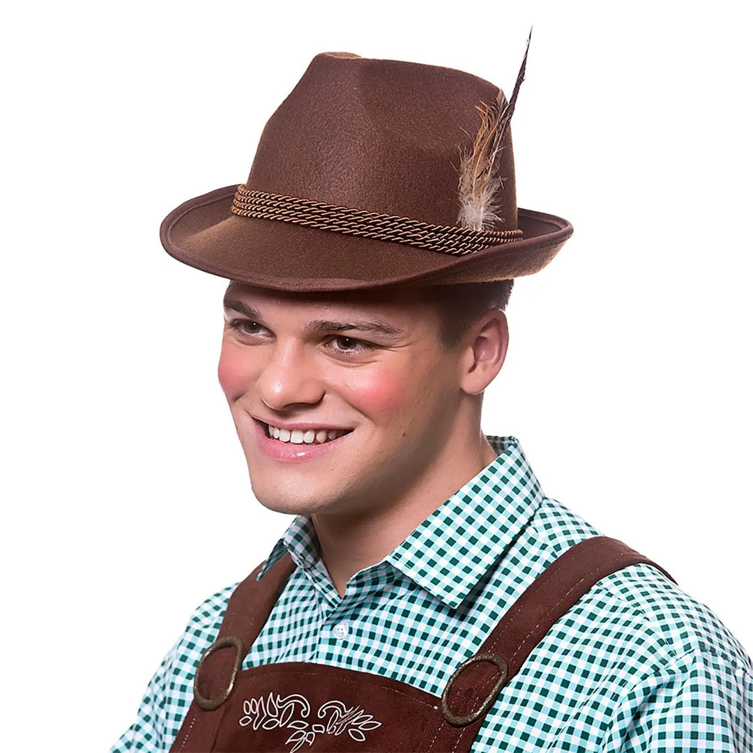 Man wearing lederhosen and a brown felt bavarian hat with braid and feathers for beer festival fancy dress