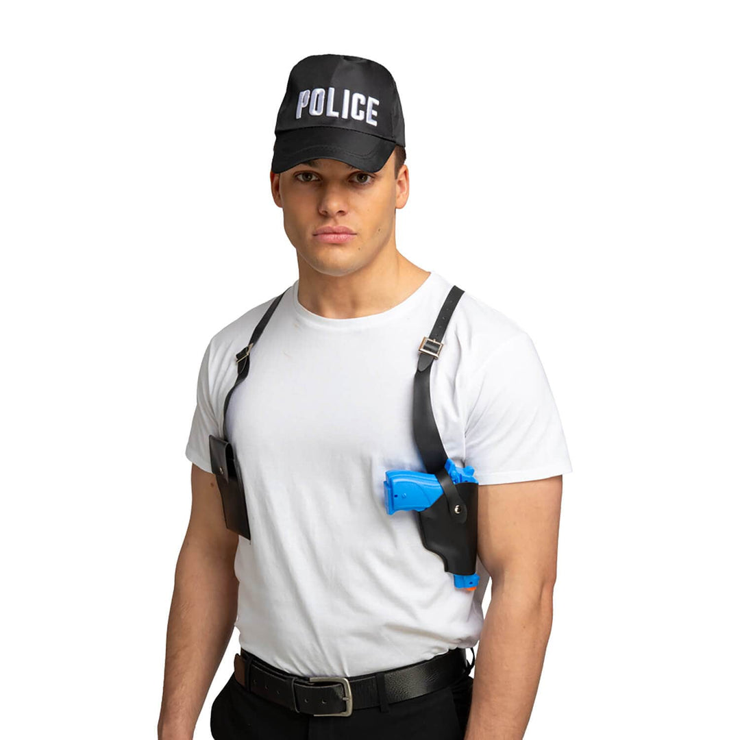 Man wearing a police cap with shoulder weapon holder and toy gun for fancy dress parties