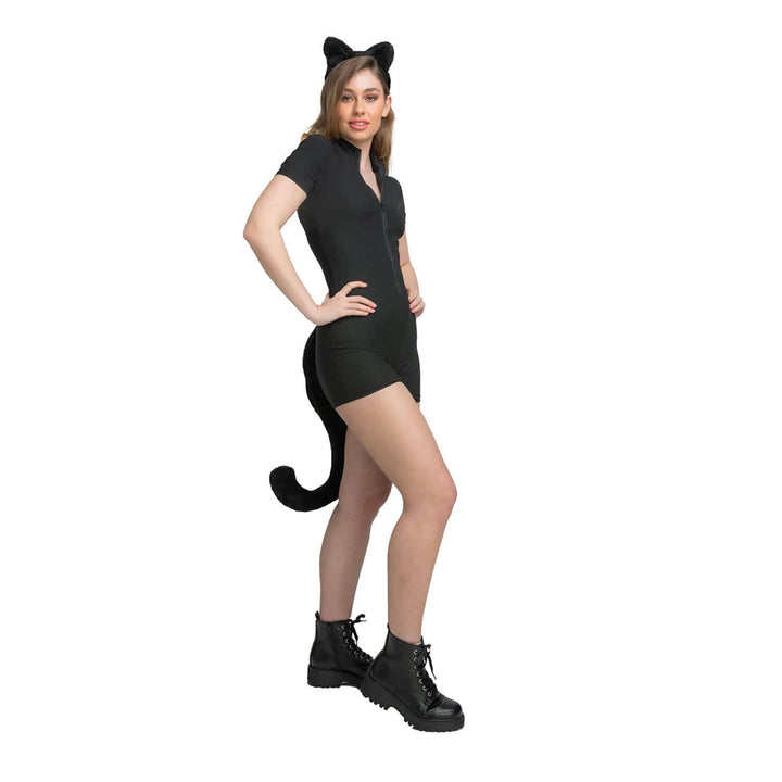 Person wearing a black cat costume with ears and a tail on a white background