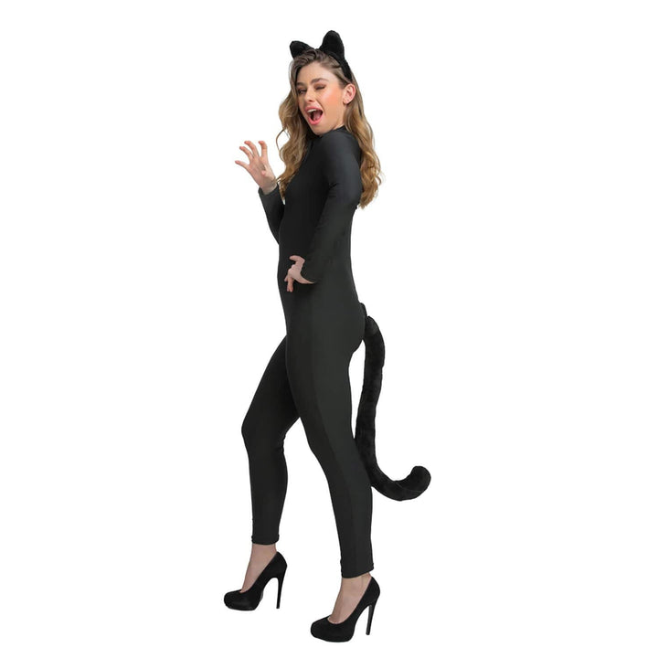 Person wearing a black cat costume with ears ans a tail on a white background