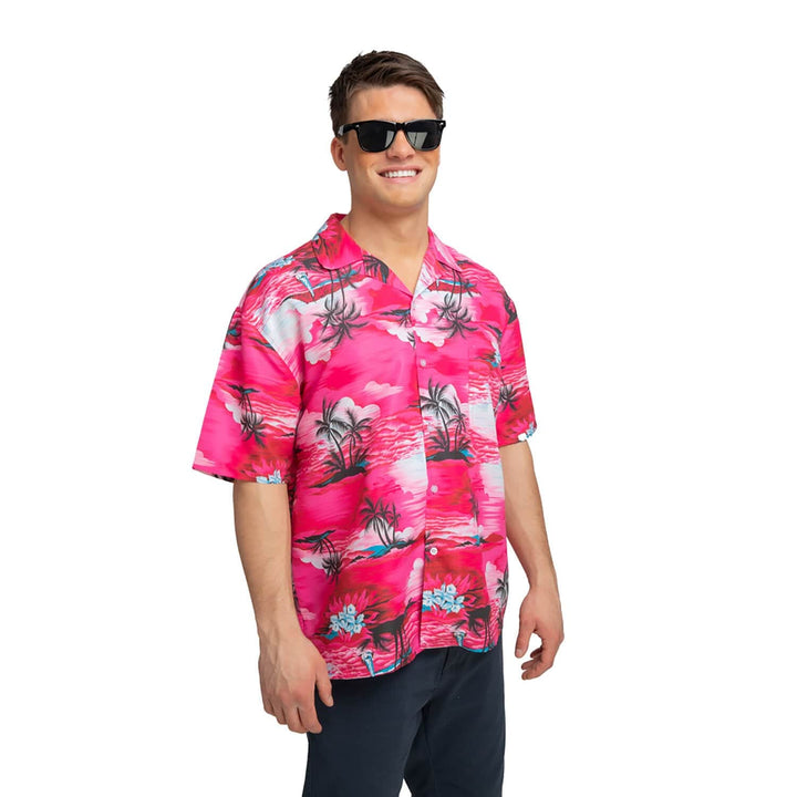 Man wearing a Hawaiian shirt with bright pink palm trees design for a beach party