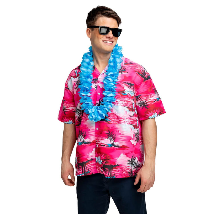 Man wearing a bright pink palm trees design Hawaiian shirt, sunglasses and a blue flower garland