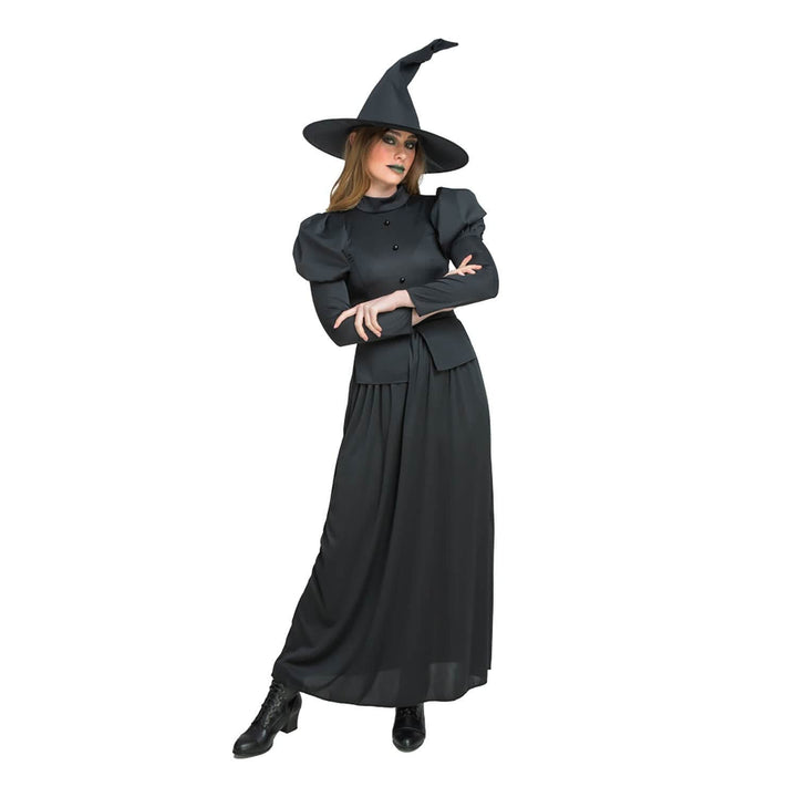 Woman wearing a black witch costume with long dress and pointed hat