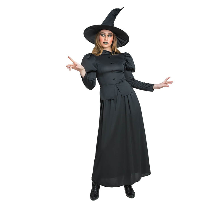 Woman wearing a black witch costume with a hat on a white background